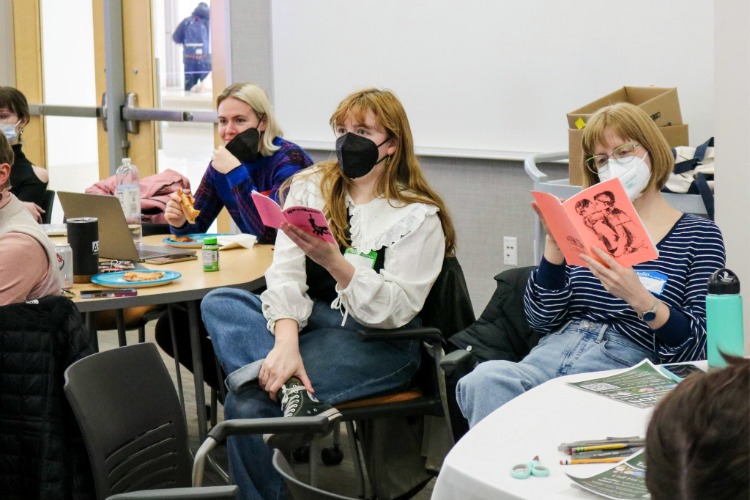 Participants read zines at the Envision Embodied Writing Workshop, organized by Izzy Fincher (April 7, 2026).