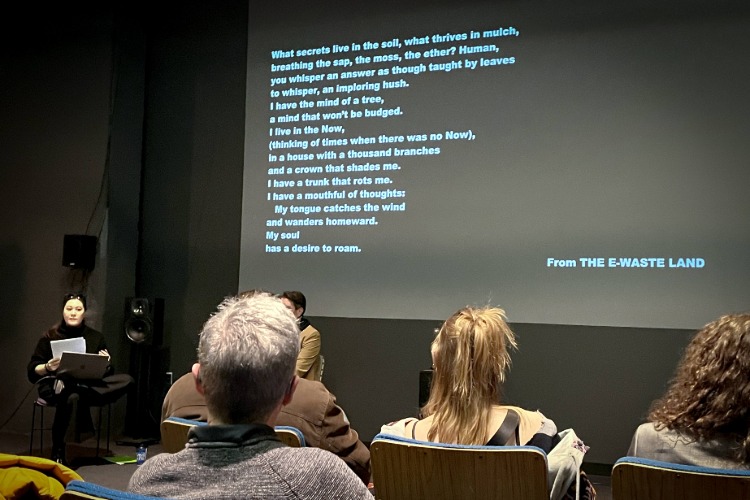 A poem is projected onto a wall during the Language as Collaborator: Co-Creating with Thinking Machines workshop, part of C21's Aesthetics, Art, & AI program series.