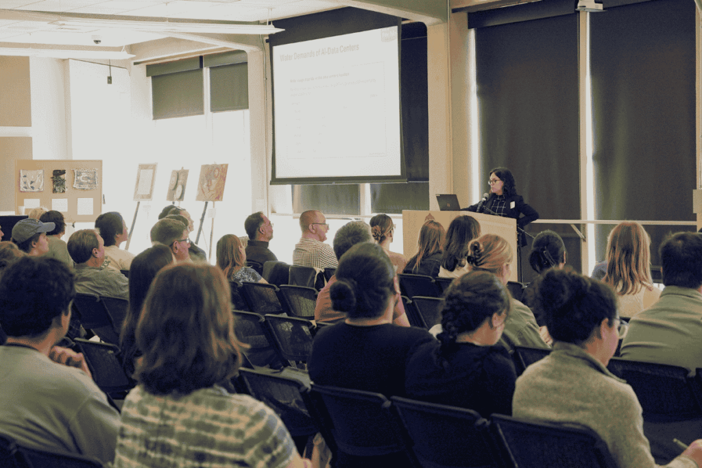 Tressie Kamp giving a presentation in front of a crowd.
