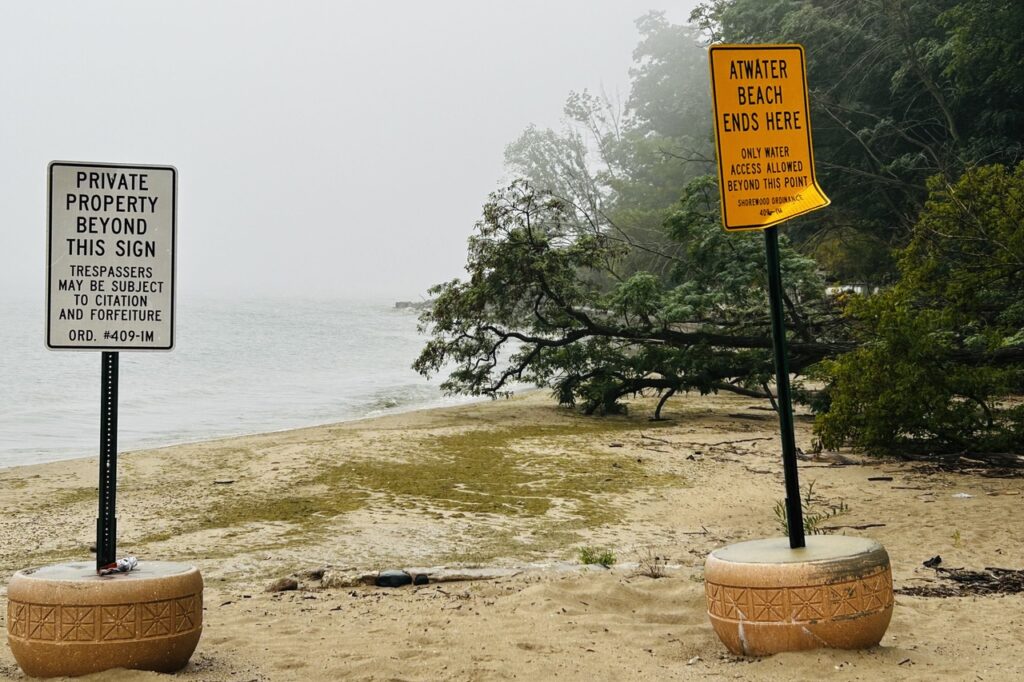Two signs indicate the end of the public beach at Atwater Beach.