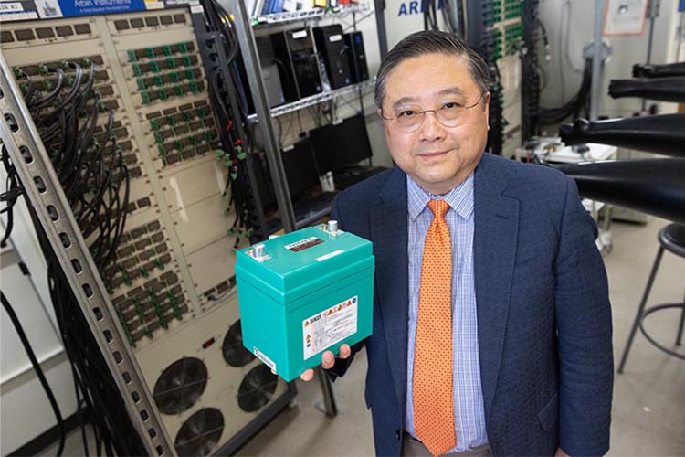Professor Qu holds a used EV battery.