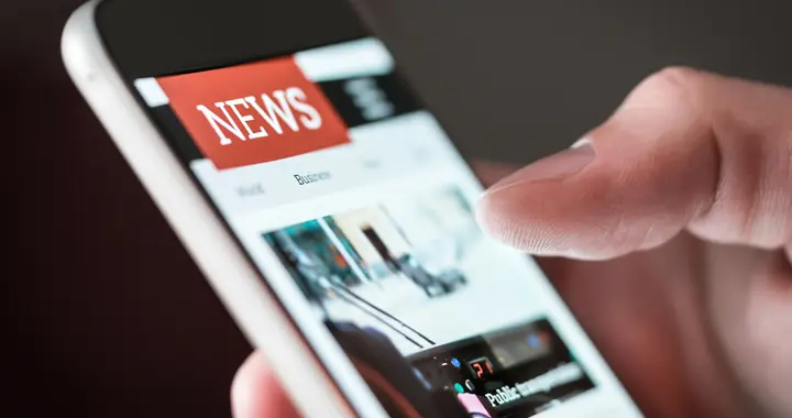 mobile phone showing "news" on screen