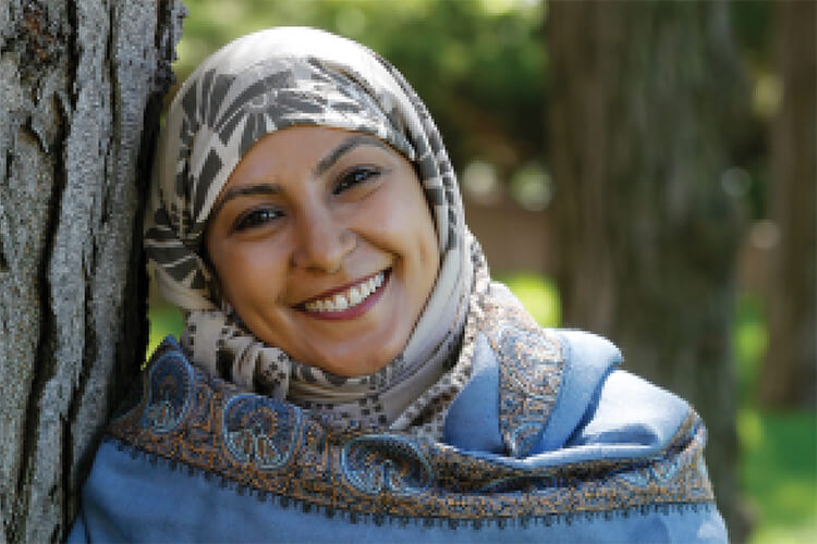 Smiling woman in hijab.