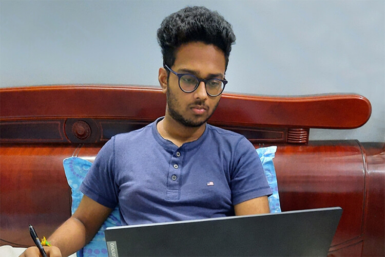 Indian student studying on laptop