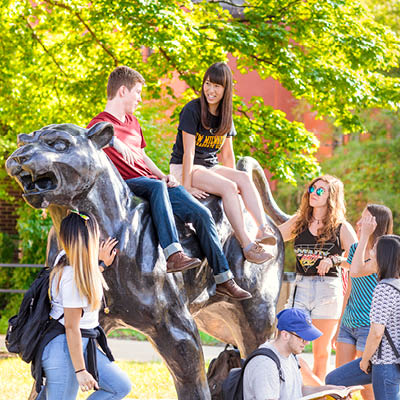 Group of students hanging out on Panther statue