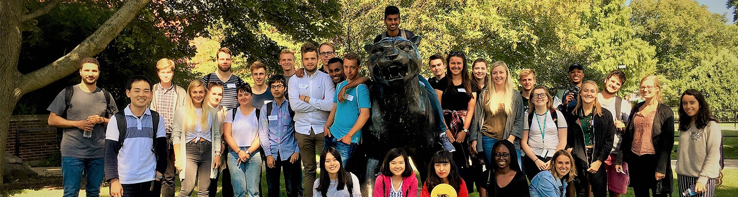 Group photo of exchange students by UWM Panther statue