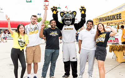 Group of five excited students with Panther mascot 