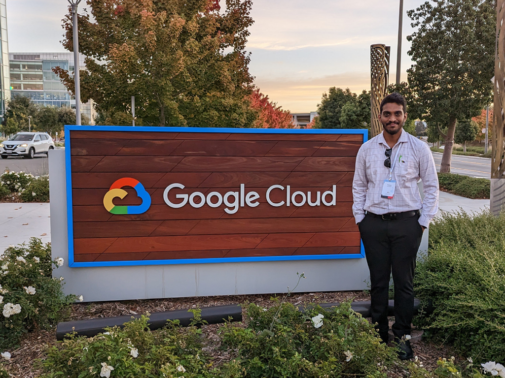 International student outside in front of sign at Google HQ