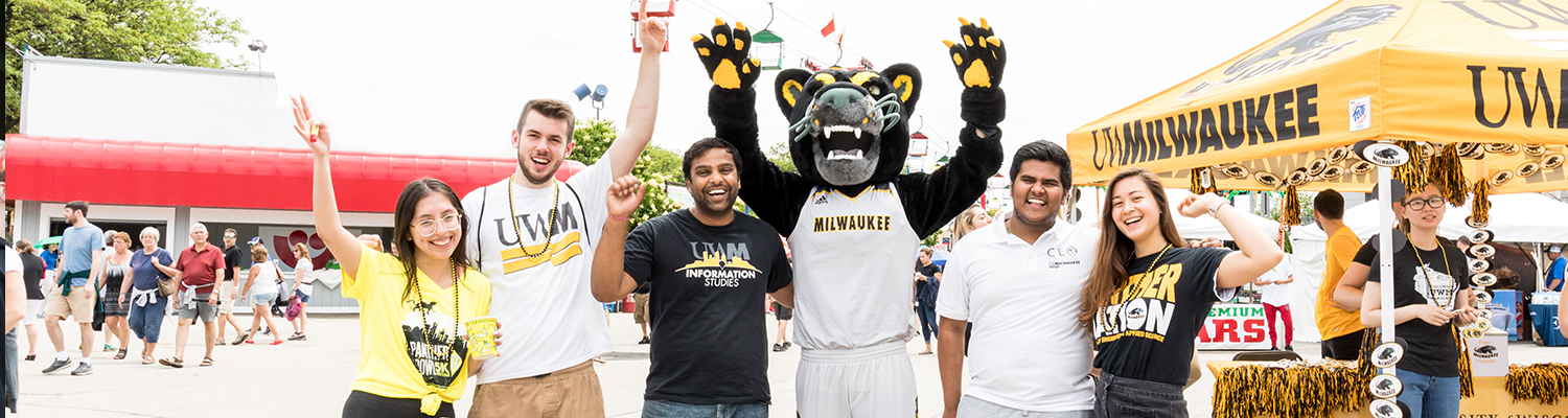 UWM students excited and standing with Pounce