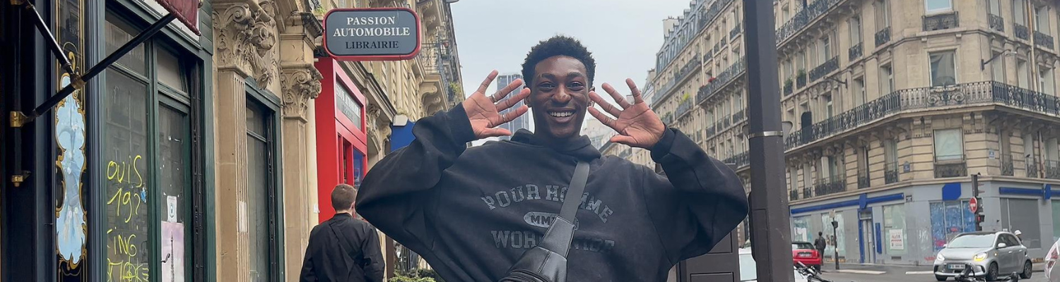 Male student smiling on a street in France
