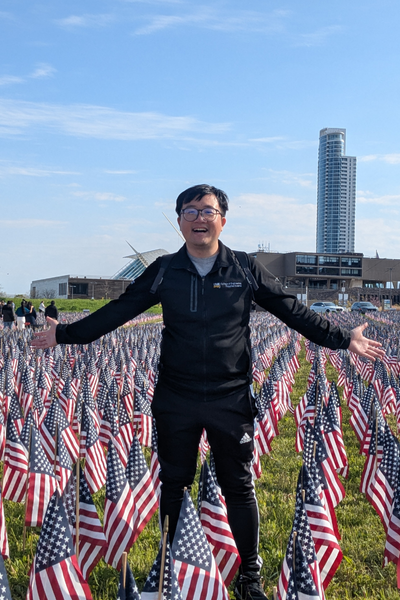 UWM Taiwanese student standing in a field of American flags