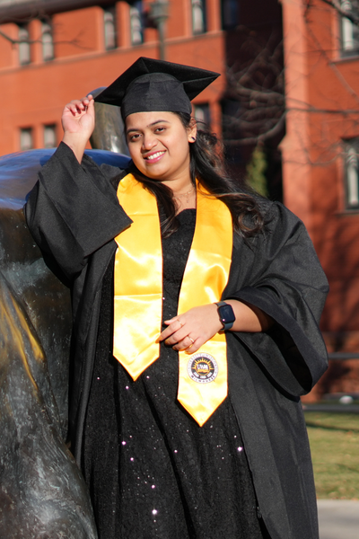 Female UWM graduate from India in cap and gown