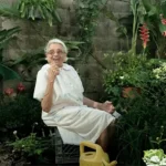an elderly person sitting in a garden