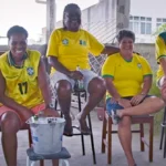 a team of people sitting and drinking beer