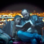 one person reading a book to another