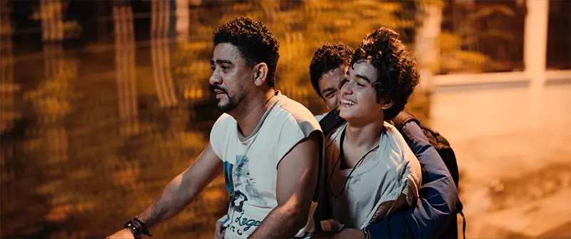 three people on a scooter