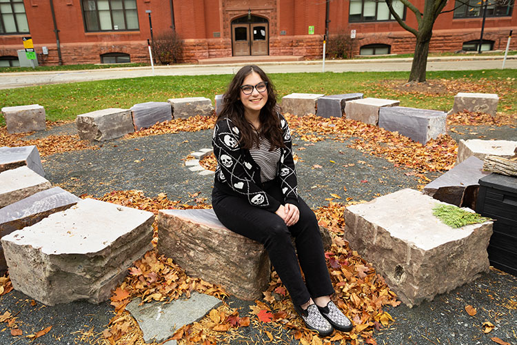 School of Education student Elizabeth Hennessey (american indian woman), sitting outside on the UWM campus