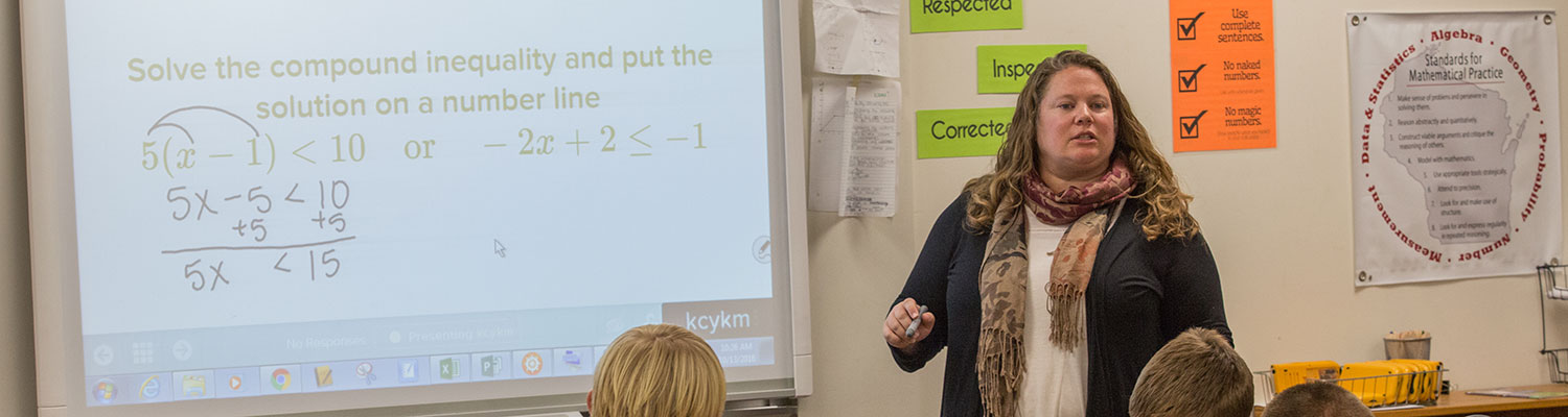 Melissa Hongsermeier (white woman) working with her ninth grade algebra class at South Milwaukee High School to solve a math problem