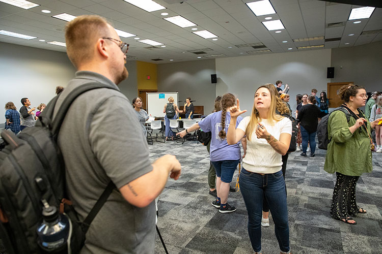Individuals in a conversation at the Deaf Wisconsin That event in 2022