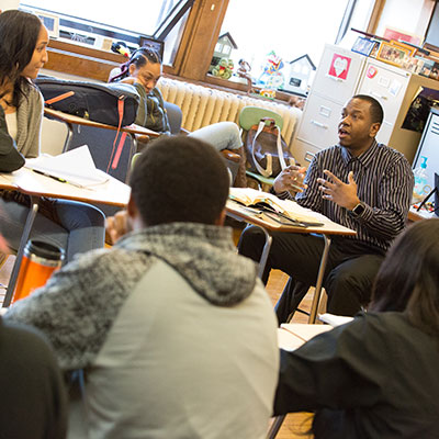 School of Education alumni Nate Deans (african american man) teaching students in his classroom
