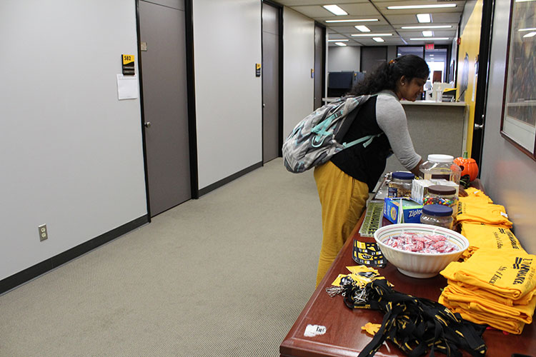 Jasmine Padeti (graduate student) looking through the snack and swag table.