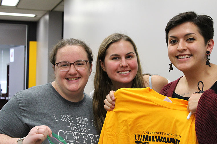 Rachel Cesar (senior), Erika Wendt (senior), and Samantha Raszesja (senior) posing for a picture with a School of Education t-shirt.