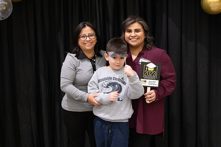 Thelmy Maldonado, who earned her master’s in social work, with her mom and little brother, Brody.