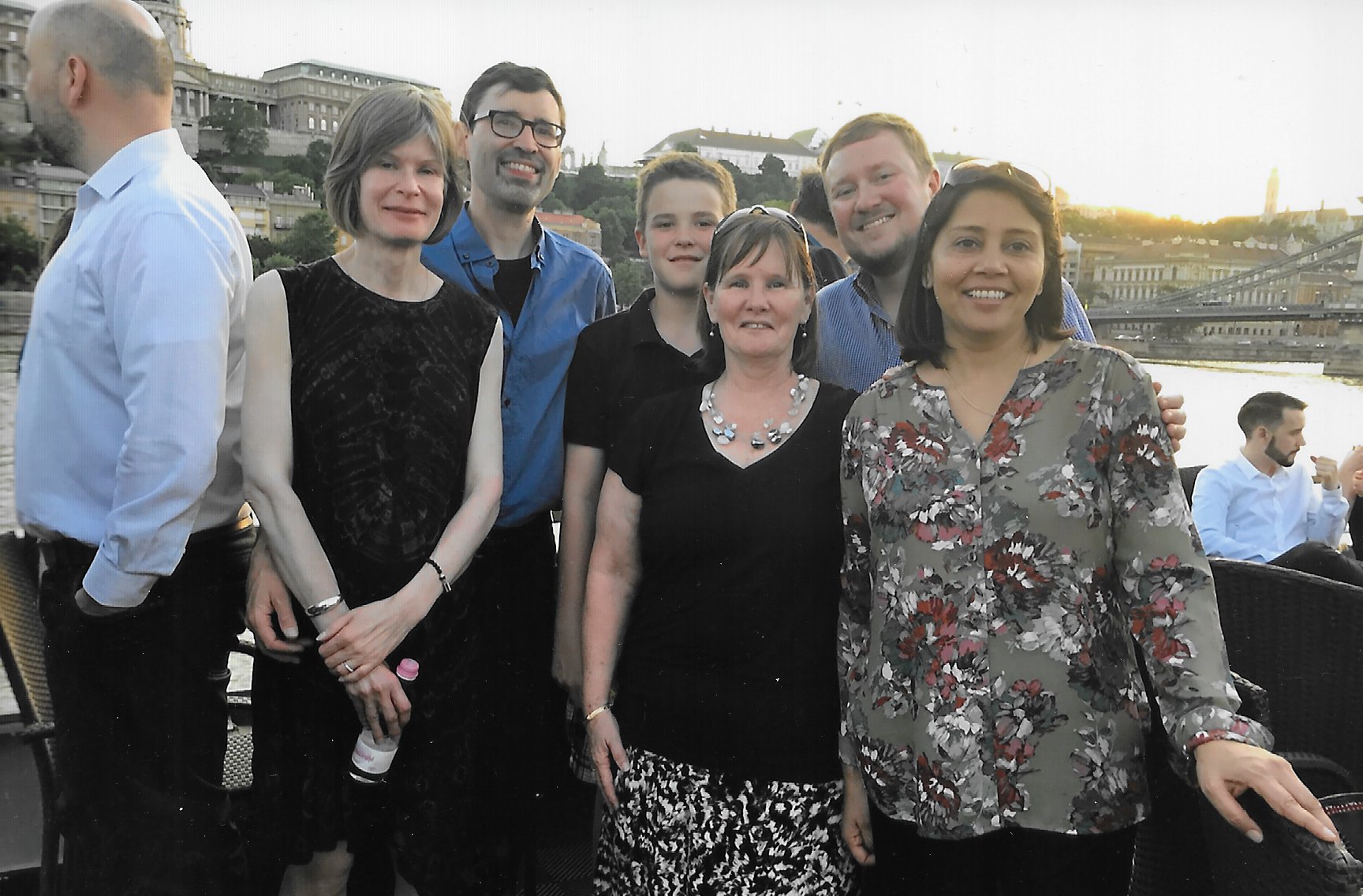 group of six individuals (3 male in back row and three females in front row) standing outdoors in Budapest. 