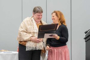 Shelia Feay-Shaw and Maurina Paradise looking at award