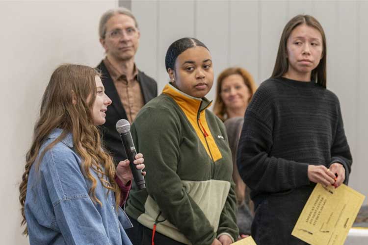 Graduate students sharing pieces of their journey with audience. 