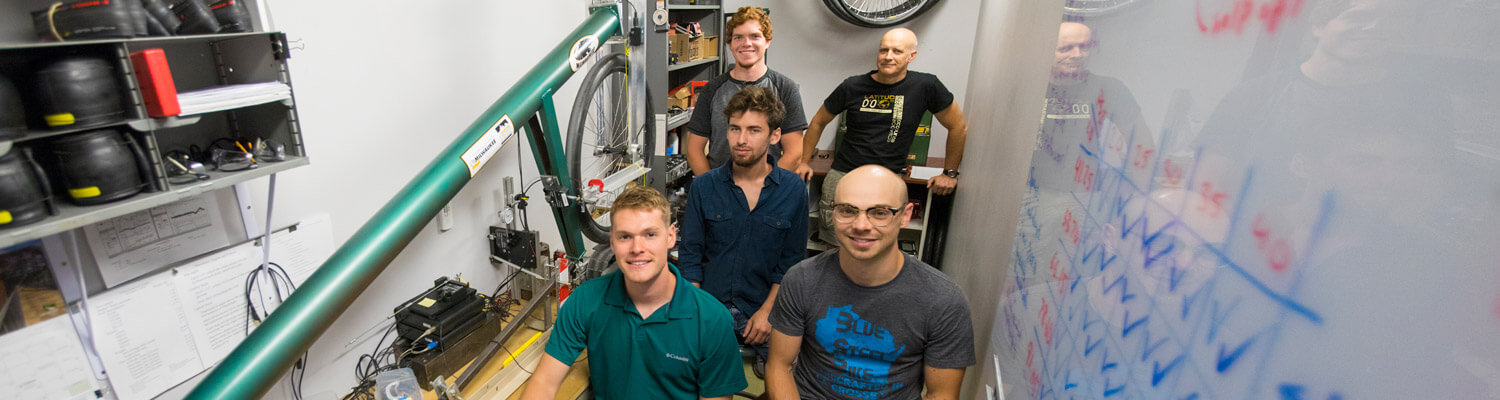 four students and Andy Dressel in bike lab