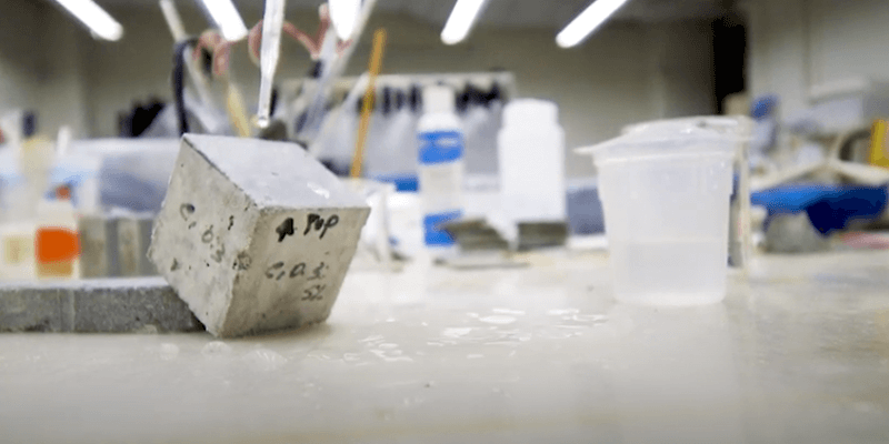 close up of small concrete cube on lab table