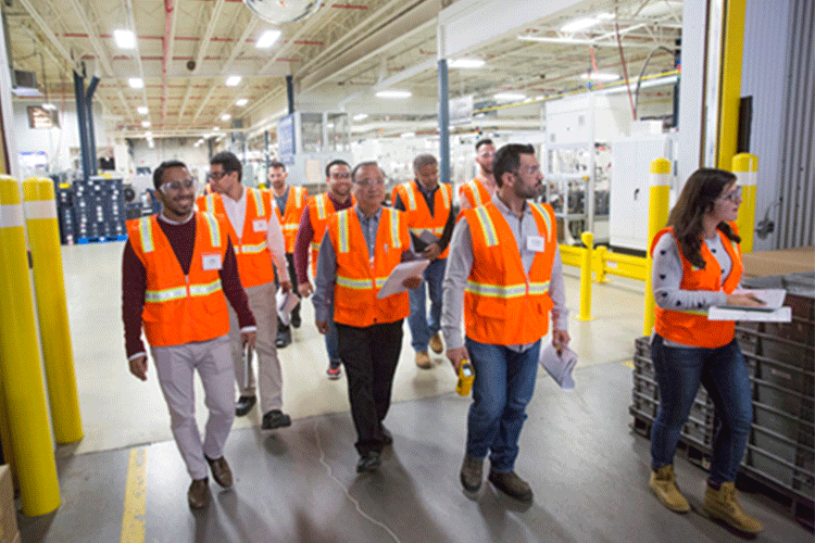 group of people touring a factory