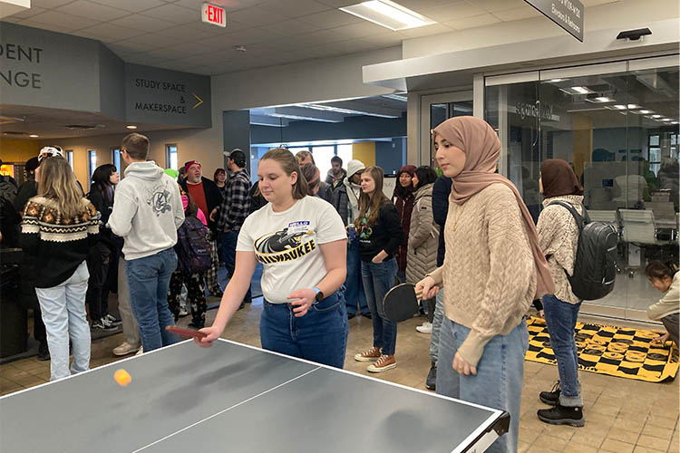 two women playing ping pong. two women playing ping pong.