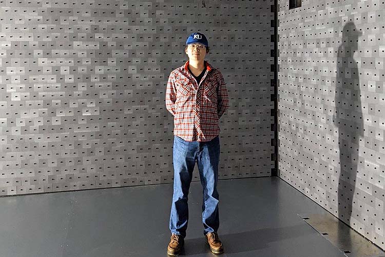 Man is standing in the Electromagnetic Interference Testing Facility used by industry to measure noise