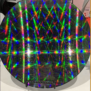 An environmental sensor, a small black disk with irridescence reflections.  