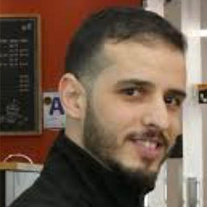 headshot of a man with a mustache and beard