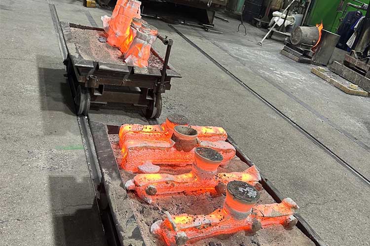 Red hot molds made of ceramic emerge from the casting furnance.