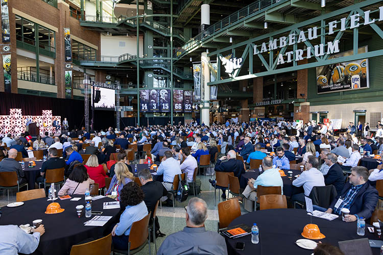 A large crowd faces the stage at the Lambeau Field indoor Atrium. A large crowd faces the stage at the Lambeau Field indoor Atrium.