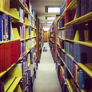 Picture of the UWM library, looking through the bookshelves.