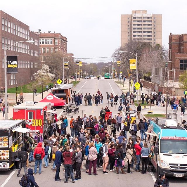 Picture of a UWM street that has been closed to allow students to visit the numerous food trucks in the street.