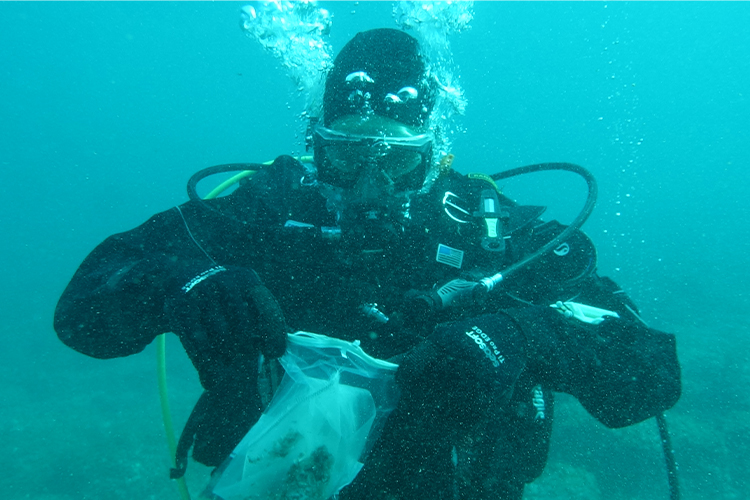 student Tyler Kunze underwater diving
