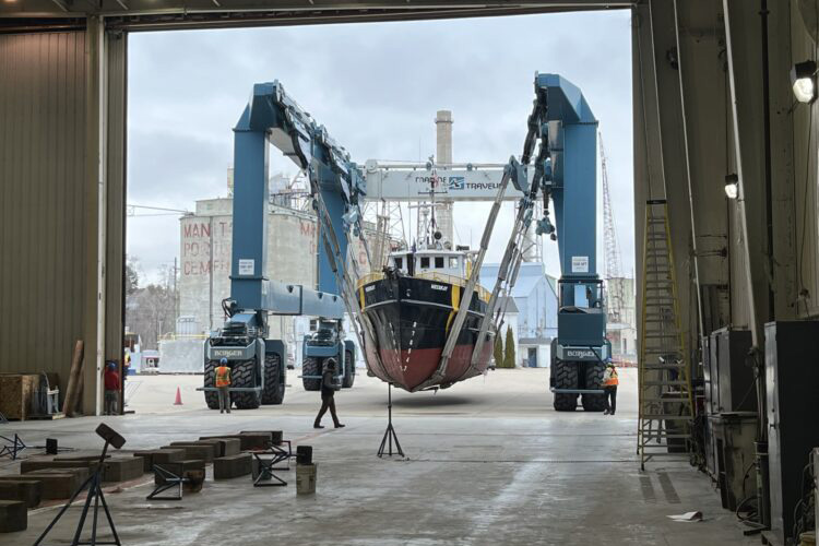 Neeskay being loaded into a warehouse garage