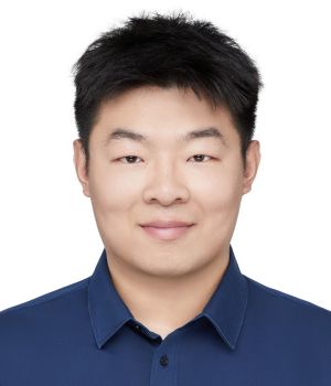 A man smiles against a white background.