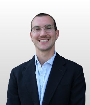 Thomas Dunbar smiling against a white background.