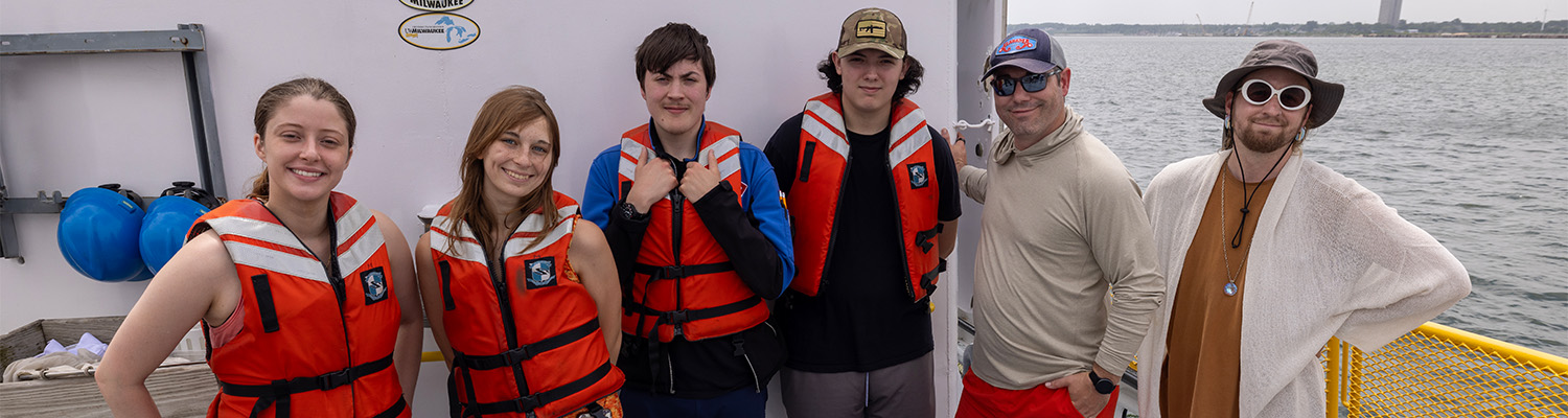 Students pose on the deck of the Neeskay.