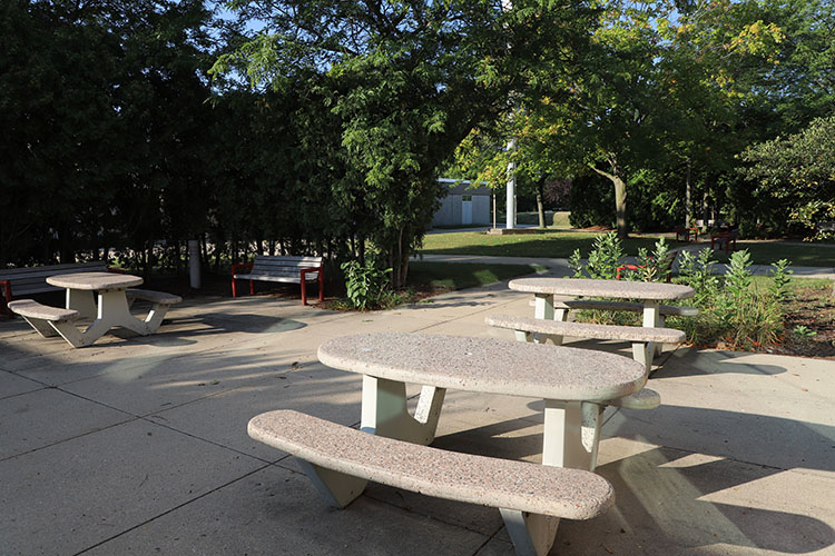 Courtyard picnic and social green space at UWM at Waukesha, between the Fieldhouse and Hub indoor spaces.
