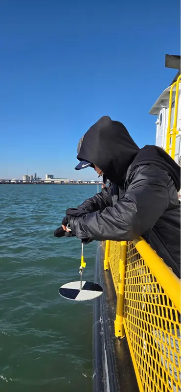 Tiffany lowering a Secchi disk.