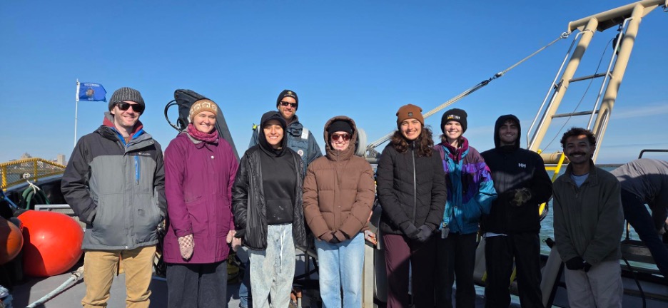 Graduate and undergraduate students with Captain Max on the Neeskay research vessel. 