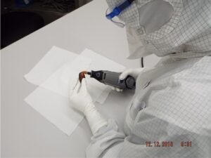 Person in lab working on rock